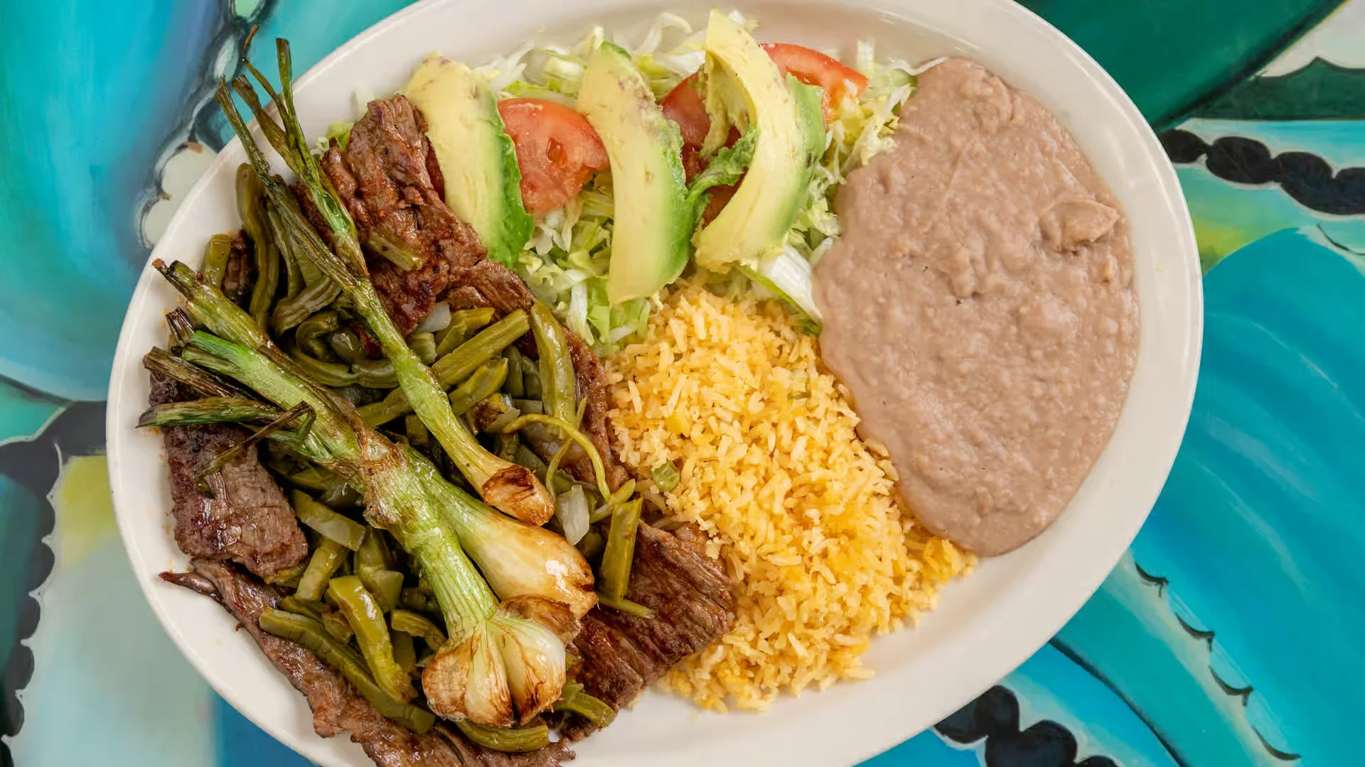 Carne Asada Taco - Grilled marinated beef on a fresh corn tortilla, topped with cilantro, onion, and our house salsa. A true crowd favorite.