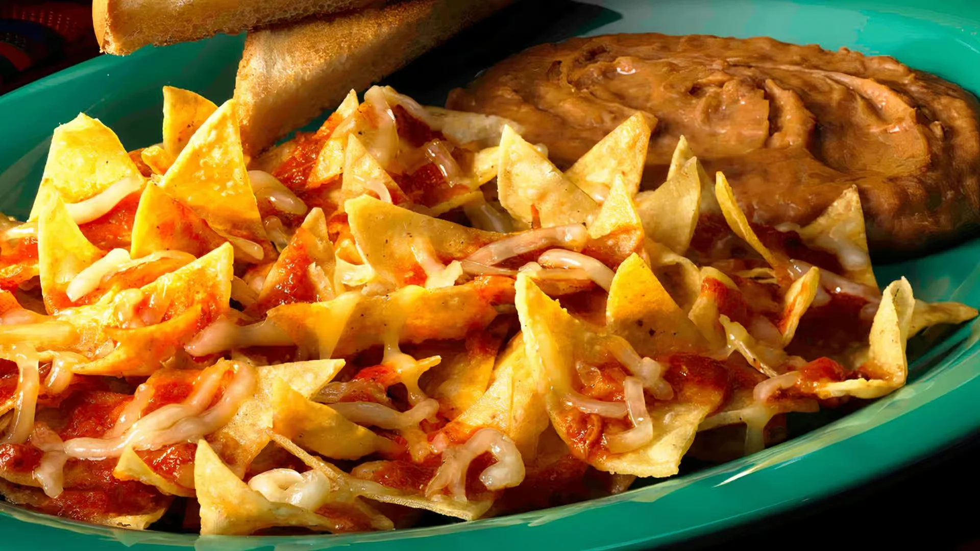 Chilaquiles Plate - Crispy tortilla chips simmered in salsa, topped with eggs and cheese